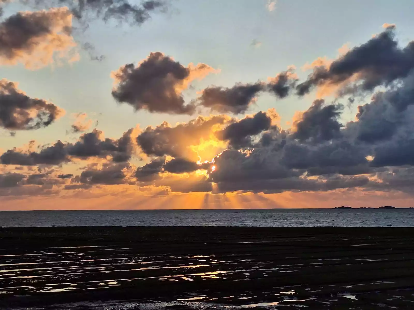 Sonnenuntergang über der Nordsee bei Pellworm mit eindrucksvollem Wolken- und Lichtspiel